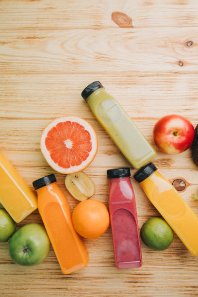 istock Fruit and vegetable smoothies in transparent plastic bottles. Red, green, orange smoothies on a wooden table. The concept of healthy eating 2091895541