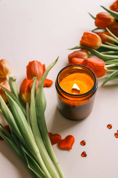 istock Candle and bouquet of red tulips, spring aesthetics 2091896064