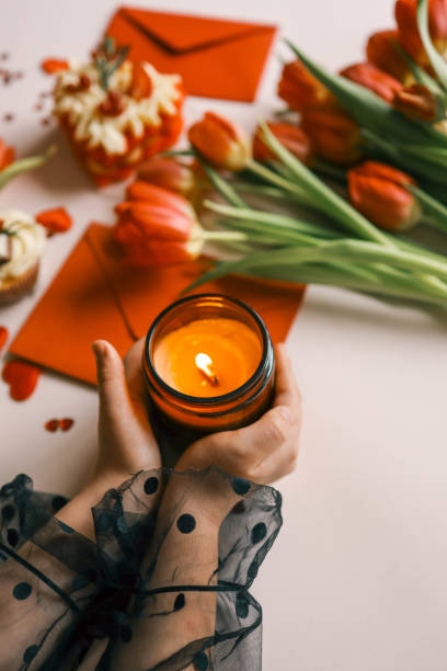 istock Candle and bouquet of red tulips, spring aesthetics 2091896073