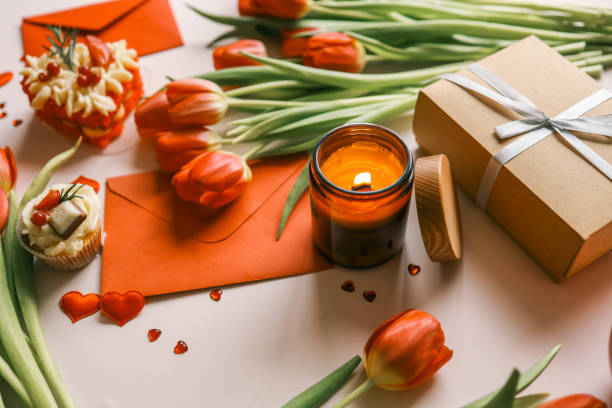 istock Beautiful spring background, burning candle, red tulips, gift box and cake 2091896075