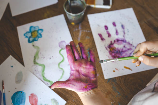 istock Children's drawing workshop, happy children make handprints with paint 2091915422