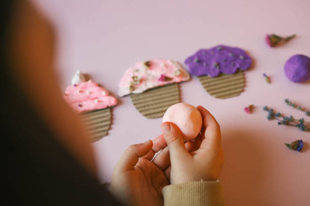 a child sculpts from plasticine, an idea for an activity - school classroom child back to school stock-fotos und bilder