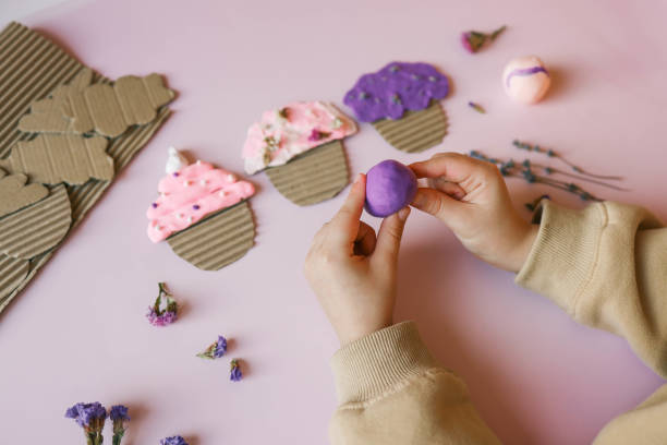 a child sculpts from plasticine, an idea for an activity - school classroom child back to school stock-fotos und bilder