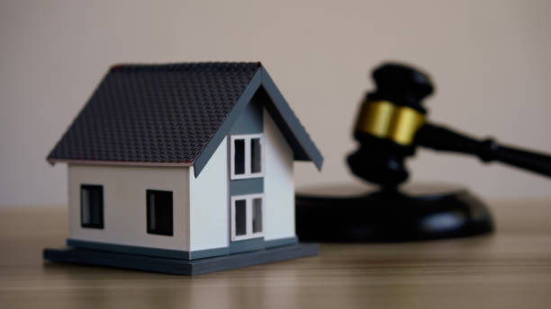 istock House model, hammer judge gavel on wooden table with white wall background. Foreclosure, bankruptcy concept. Person is unable to repay outstanding debts or obligations, stops mortgage payment. 2091960958