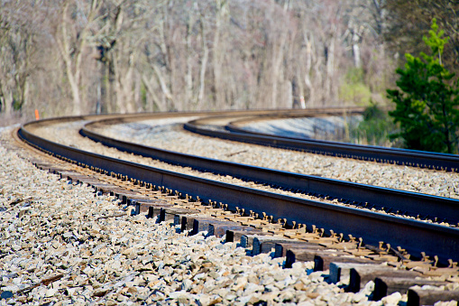 Railroad tracks in heavy rain, water reflections abstract. Wet train tracks, water on railway closeup, detail. Sad, melanholic view, nobody. Relaxation background, relaxing rain, calm, serene scene