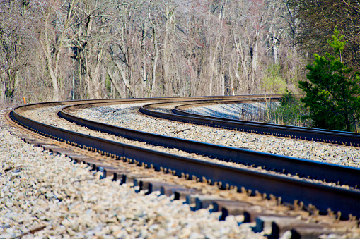 Railroad tracks in heavy rain, water reflections abstract. Wet train tracks, water on railway closeup, detail. Sad, melanholic view, nobody. Relaxation background, relaxing rain, calm, serene scene