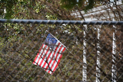 American flag behind a steel fence