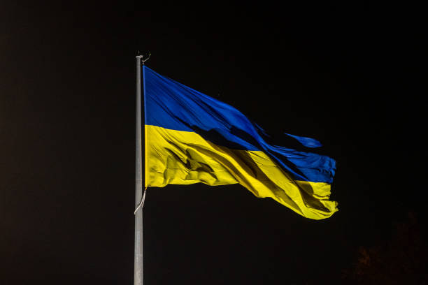 istock Ukrainian national official flag blowing on night sky background 2091993924