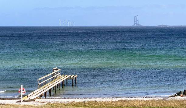 Breathtaking ocean vista overlooking Nyborg Beach with the majestic backdrop of the Great Belt Bridge.