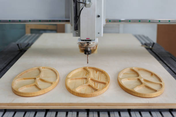 Making dishes from wood on a CNC machine in the workshop.