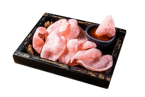 Vietnamese  Crunchy kerupuk, prawn shrimp crackers, chips in a box with sauce.  Isolated on white background. Top view