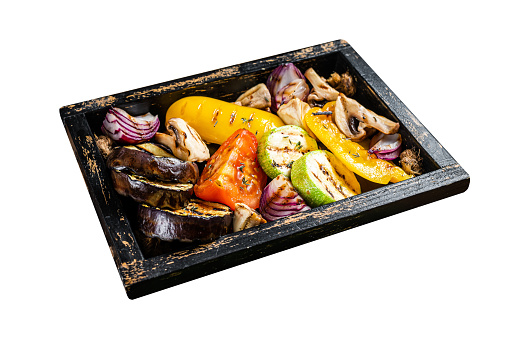 Assortment of grilled Vegetables in a wooden box, bell pepper, zucchini, eggplant, onion and tomato.  Isolated on white background. Top view