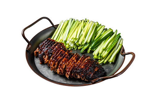 Peking Duck served with cucumber, green onions, and roasted wheaten chinese pancakes with sauce Hoysin. Isolated on white background. Top view