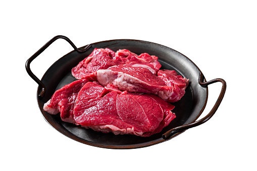 Raw Lamb leg steaks on butcher table. Isolated on white background. Top view