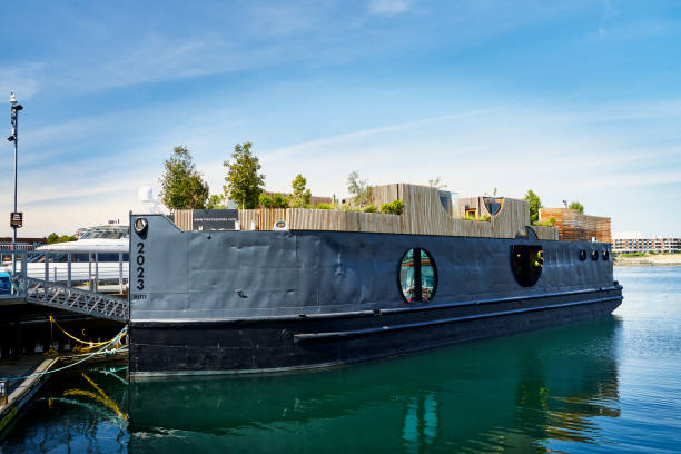 Victoria, Canada – June 09, 2023: Havn floating spa, saunas, hot and cold pools with green social spaces on a repurposed 1943 marine vessel.