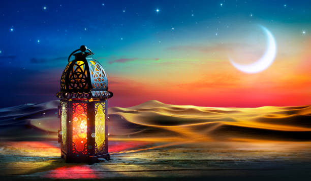 istock Ramadan Kareem - Arabic Lantern At Dawn In Desert With Crescent Moon In Starry Sky - Abstract Glitter In The Candlelight 2092054068