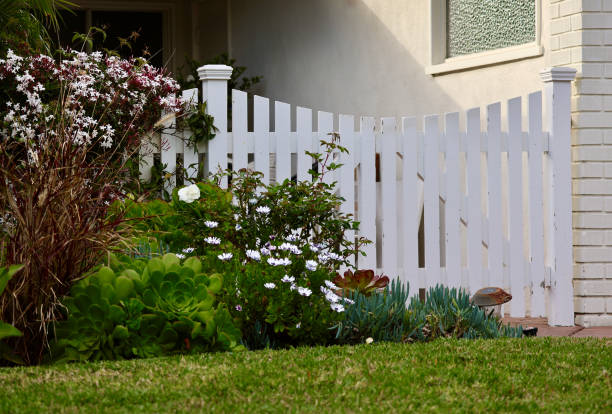 istock Flowerbed in bloom along the white picket fence 2092054574