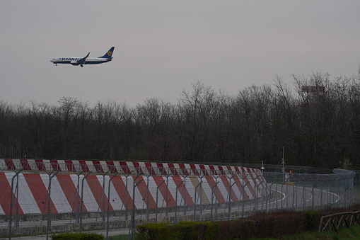 Antonov An-22 turboprop cargo plane on the taxiway and Antonov An-225 Mriya on the background