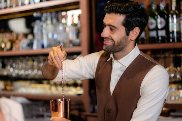 istock Man bartender is making a drink and dancing at bar. Dance party with group people dancing . Women and men have fun and drinking martini cocktail in night club. 2092116102