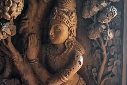 Wooden sculpture of a hindu God on the wall of scantuary of truth, Pattaya