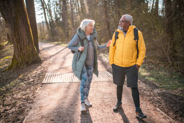 istock Active Senior Couple Hiking in Forest 2092134486