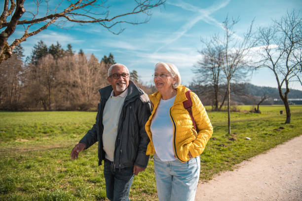 istock Senior Diverse Couple Enjoying a Walk in the Park 2092134488