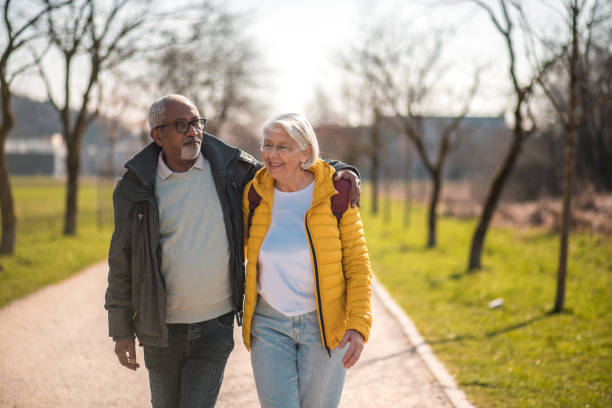 istock Active Senior Couple Enjoying Walk in Park 2092134505