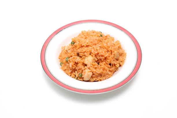 Fried rice with chicken and green peas in a plate on white background
