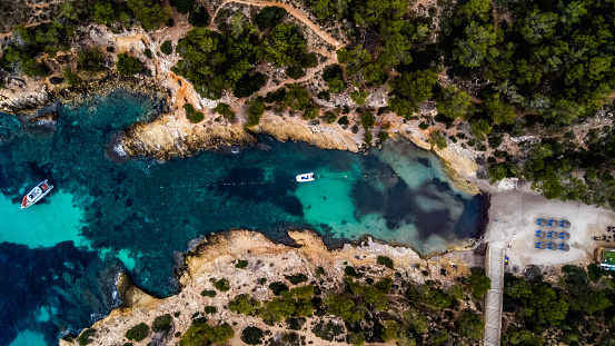Cala Falco, a secluded cove nestled on the rugged coastline of Mallorca, Spain. The cove is renowned for its pristine waters, dramatic cliffs, and idyllic atmosphere, making it a true hidden gem for those seeking a tranquil escape.