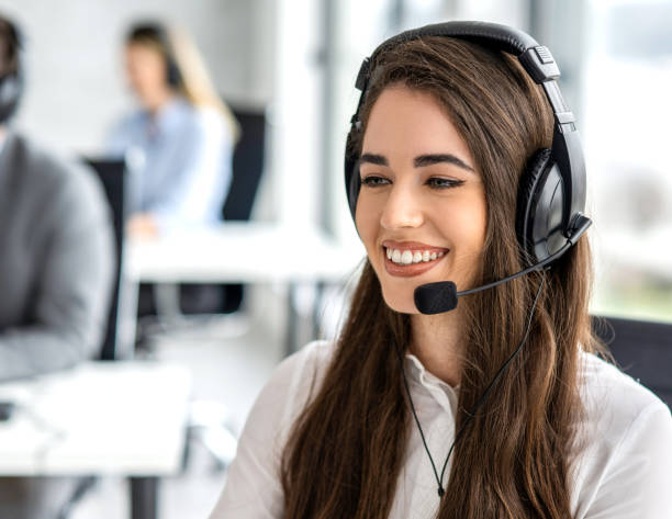 istock Phone worker with headset providing technical support to users by researching and answering questions at call centre. 2092181604