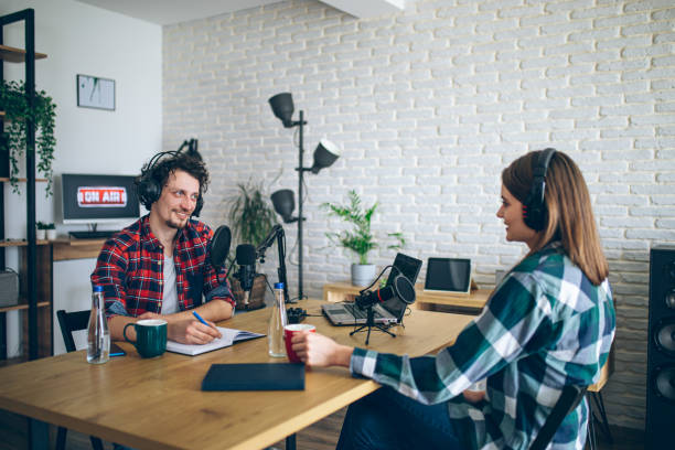 istock Two people recording a podcast in a studio 2092184733