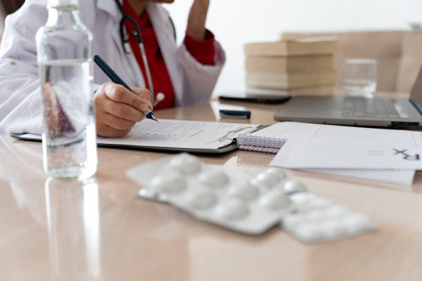 istock Doctor is making notes while listening to his patient. 2092192112