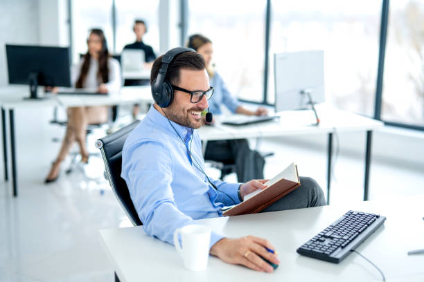 istock Busy male call center agent checking database on computer in IT helpdesk center. 2092218539