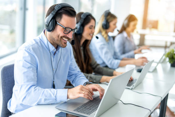 istock Group of call center agents working on laptops. 2092229594