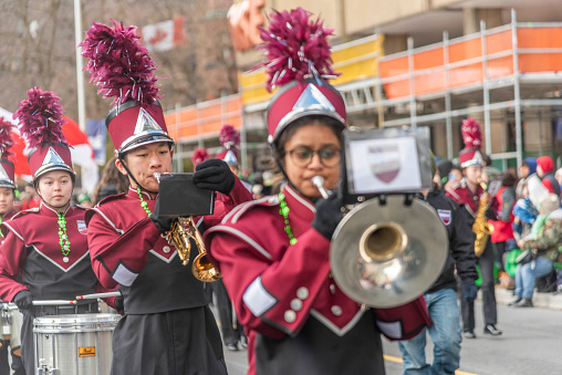 Toronto Ontario, Canada- March 17th, 2023: an asian marching band in the St. Patrick's Day parade in Toronto.