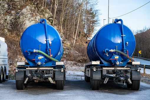 Lindesnes, Norway - december 23 2023: Two blue tanker trailers on a parking lot.