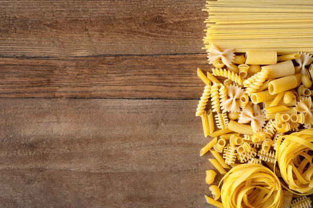 istock Different types of Italian pasta on rustic wooden table. 2092274352