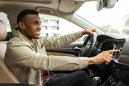 African american man using gps navigation system in car to travel. High quality photo