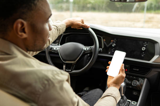 istock Unrecognizable Black Driver Guy Using Mobile Phone With Blank Screen Sitting In Automobile. Car Navigation App. 2092306271