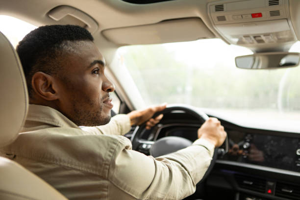 African american man driving a modern car African american man driving a modern car. High quality photo black man stock pictures, royalty-free photos & images