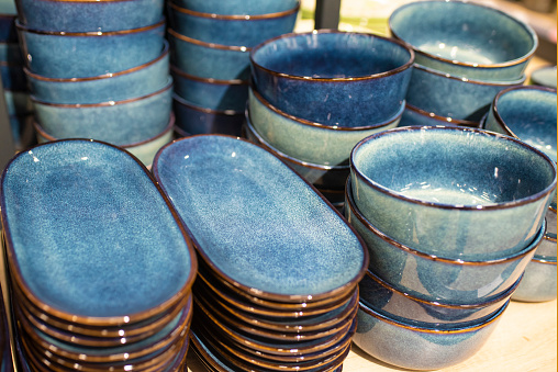 Ceramic blue tableware on the counter of the store, close-up