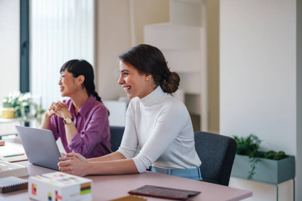 istock Professional Women Laughing in a Casual Office Environment 2092321332