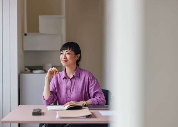 istock Professional Woman at Work with Pen and Notebook in Office 2092321787