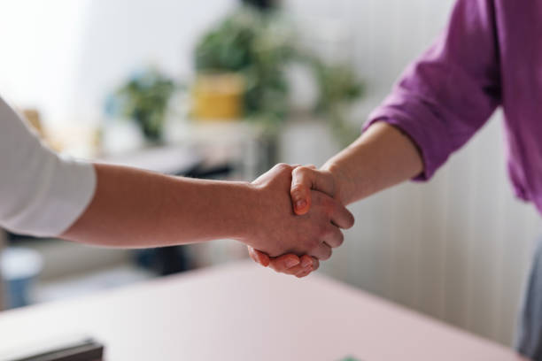 istock Two People Shaking Hands in Informal Setting Close-up Shot 2092321788