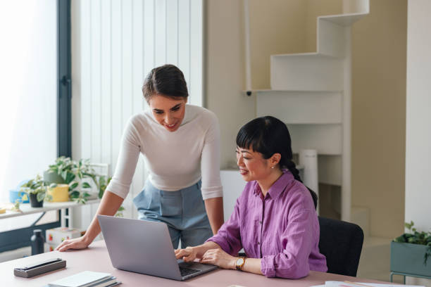 istock Two Professional Women Collaborating at a Laptop in an Office 2092321789