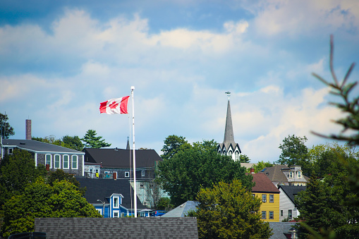 Lunenburg, Nova Scotia, Canada - August 2023:\nView of some waterfront houses from across the bay, in the historic fishing town and UNESCO heritage sight of Lunenburg.