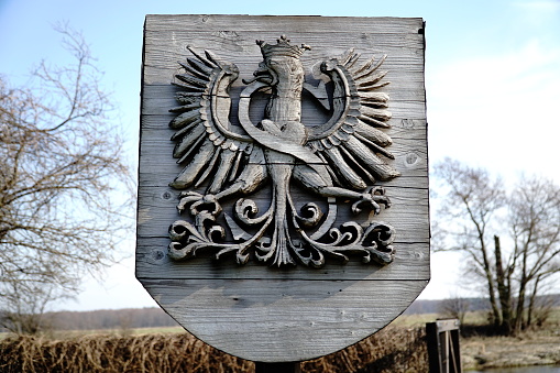 Liw, Poland - March 10th, 2024 - Polish coat of arms - wooden sculpture at medieval castle.