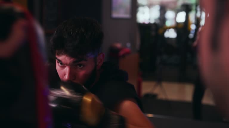 Young man punching training on punching pads.