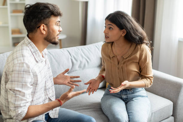istock Angry indian couple having quarrel experiencing crisis in relationship, sitting on sofa and having conflict at home. Marital problems, divorce concept 2092374643