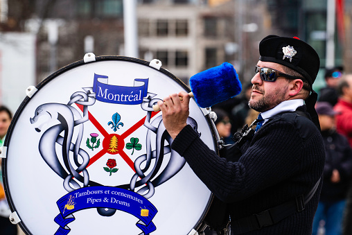 Montreal, Canada - March 18 2024: Marching band with traditional British uniform parading in the Saint Patrick`s Day in Montreal downtown